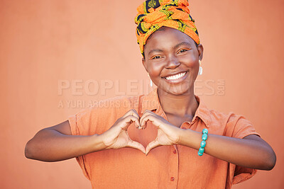 Buy stock photo Black woman, hands or heart sign on wall background with fashion, trendy or stylish clothes for love, support or trust. Portrait, smile or happy student and hand gesture, hope emoji or orange mockup