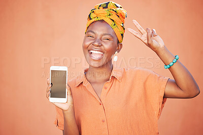 Buy stock photo Mockup, phone or happy black woman with peace hand gesture against orange wall with cool retro African fashion. Smile, face or excited girl portrait with screen for product placement or marketing