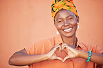 Portrait of black woman, heart hands and emoji for love, care and kindness, trust and support on orange background. Happy, smile and girl, finger shape and wellness for self care, peace and happiness