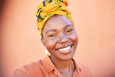 Face, portrait and selfie of black woman in turban in studio on an orange mockup background. Fashion, makeup and female from Nigeria taking pictures for happy memory, social media or profile picture.