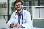 Doctor, desk and phone with smile for texting, communication or chatting and good connection at hospital. Happy man healthcare or medical professional smiling for telecommunication service at clinic