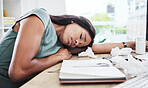 Woman, tired and sleeping on office desk in burnout suffering from stress, depression or mental health issues. Exhausted female employee worker resting, dreaming or asleep on computer table at work