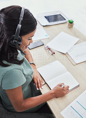 Buy stock photo Customer support, call center and black woman writing in notebook for schedule, planning and feedback. Contact us, receptionist and female consultant in customer service, help desk and telemarketing