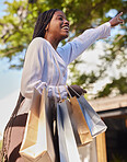 Black woman, shopping bags and outdoor on city street while happy and hailing for a taxi or cab to travel on consumer journey. African female with hand up for transport with a smile after retail sale