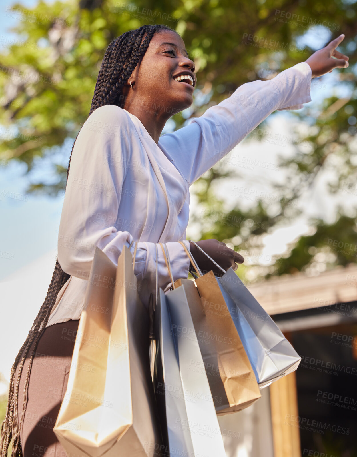 Buy stock photo Black woman, shopping bags and outdoor on city street while happy and hailing for a taxi or cab to travel on consumer journey. African female with hand up for transport with a smile after retail sale