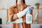 Woman, spring cleaning and spray bottle with arms crossed for housekeeping, sanitation or disinfection of dirt, bacteria and dust in home. Closeup maid, chemical cleaner product and house maintenance