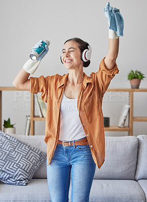 Buy stock photo Happy, dance or woman cleaning with music streaming on headphones to relax to radio audio at home. Smile, wellness, or excited cleaner dancing with cloth or spray bottle to wipe dirty dusty bacteria