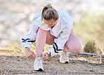Fitness, hiking and shoes of woman with laces on ground for outdoor workout, training or exercise for marathon, wellness and health. Sneakers, fashion and sports runner girl ready for running in park