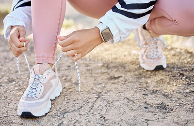 Buy stock photo Shoe, fitness and woman prepare for athletic marathon in nature for cardio health and wellness. Footwear, hand and ground with a female athlete getting ready for exercise or workout in a park