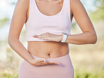 Hands, health and fit woman frame stomach while on a morning jog or run in nature for digestion. Abs, abdomen and active, athletic female framing her tummy for healthy digestion and exercise 