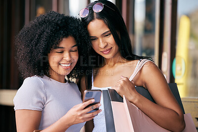 Buy stock photo Friends, phone and shopping at a mall while happy and reading bank notification for sale, savings and free gift while in city together. Females with smartphone for online customer promotion deals app