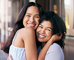 Love, happy and a couple of friends hugging in the city together while enjoying travel or free time. Portrait, face and smile with a young woman and partner bonding with a hug in an urban town