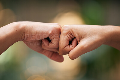 Buy stock photo Closeup fist bump, hands and greeting for friends, team or support for power, solidarity or touch. Hand connection, teamwork and motivation with knuckle, friendship and together by blurred background