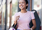 Happy, asian and woman in city with shopping bag and satisfied smile for retail products purchase. Sale, discount and promotion at shop in New York, USA with joyful consumer on sidewalk.

