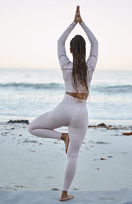 Buy stock photo Yoga, balance and black woman on beach for spiritual training, zen meditation or body workout. Tree pose, mindfulness peace and chakra energy or pilates exercise on ocean sand for fitness motivation