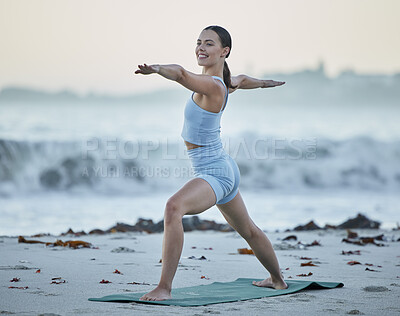 Buy stock photo Yoga, exercise and fitness woman at beach for warrior pose for balance, zen and peace during nature workout for health and wellness. Happy female doing pilates at sea for mindfulness, chakra and body