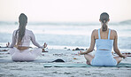 Beach, wellness and friends doing a yoga exercise for outdoor mind, body and spiritual wellness. Zen, lotus pose and peaceful women doing a pilates or meditation workout together in nature by ocean.