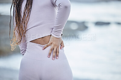 Buy stock photo Fitness, back pain and sport injury, woman runner and exercise accident outdoor, muscle ache or inflammation while running. Run, training mockup and body with pain after workout, burnout and beach.