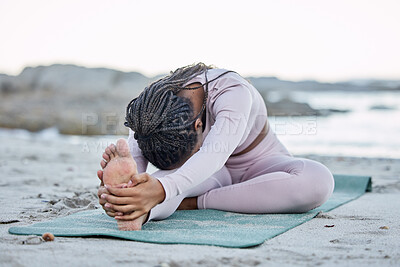 Buy stock photo Yoga, fitness and beach with a black woman stretching on an exercise mat for health or wellness in nature. Workout, training and balance with a female yogi doing a warm up by the sea or ocean