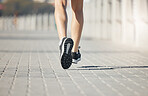 Runner, feet and woman on path to run for fitness, training and outdoor city workout. Exercise, health and wellness, close up sports shoes, girl running with motivation for growth at race or marathon