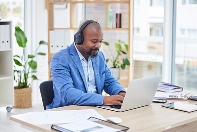 Buy stock photo Businessman, laptop and listening to music, headphones and online marketing research at desk in office. Black man, working or listen to audio, podcast or streaming with internet subscription at table