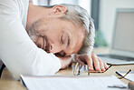 Burnout, sleeping and tired business man at his desk for financial report, audit or tax documents with time management fail or mental health risk. Fatigue, depression and sad businessman in workplace