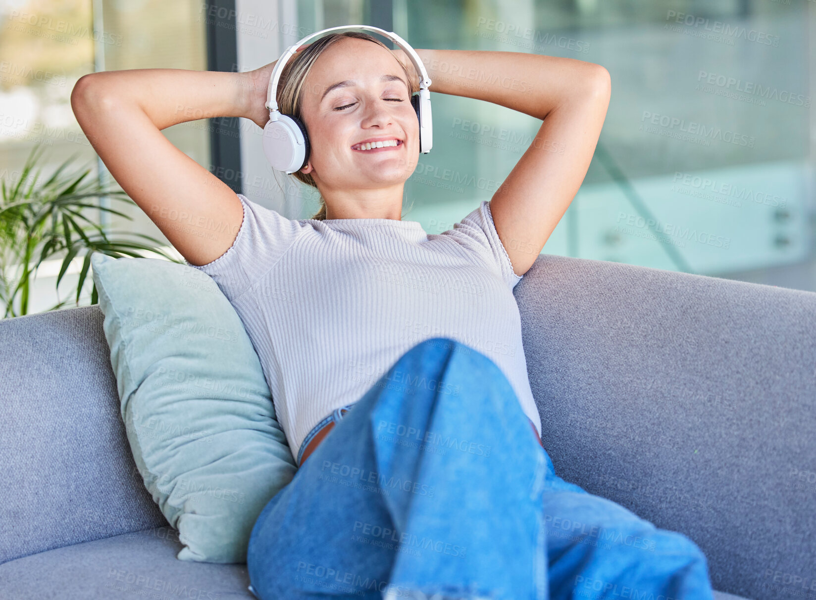 Buy stock photo Music, headphones and woman relax on sofa in home living room streaming radio or podcast. Meditation, zen and female from Canada on couch in lounge listening to audio, song or sound in house alone.