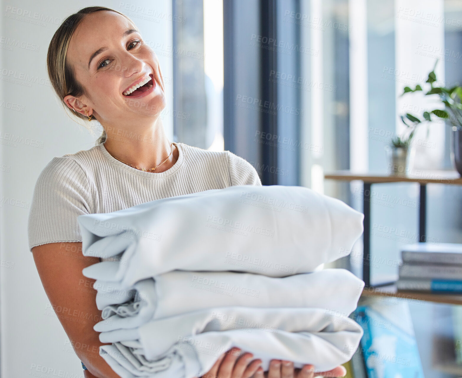Buy stock photo Woman, face or folded laundry in house, home or hotel in housekeeping, hygiene maintenance or healthcare wellness. Portrait, smile or happy maid and washing clothes, bed linen or hospitality cleaning