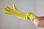 Hands, yellow rubber gloves and cleaning woman ready for worker cleaning service, spring cleaning or housework in studio background. Maid, hygiene safety wellness and bacteria maintenance uniform
