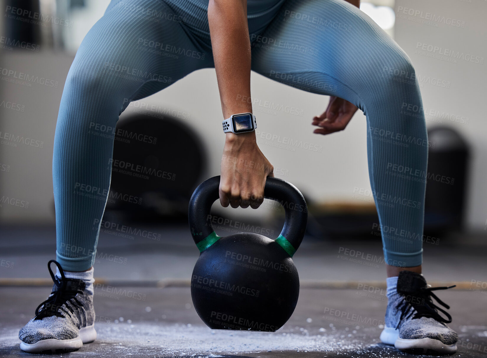 Buy stock photo Woman hand, kettlebell and gym floor in training, fitness or muscle development with smartwatch. Bodybuilder girl, weightlifting and strong with sneakers, chalk powder and focus on exercise in studio