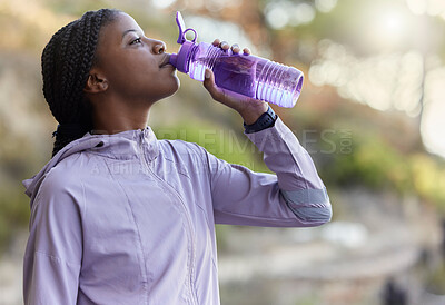 Buy stock photo Black woman runner, drinking water bottle or rest for hydration, wellness and health in summer training. Woman, running and drink water for exercise, workout or fitness at nature park in California