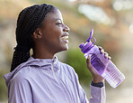 Black woman, water bottle and fitness run outdoor, relaxing and happy smile for healthy and wellness lifestyle in nature. Gen z female, hydrate and drink after exercise, cardio workout and happiness