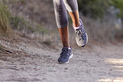 Buy stock photo Running, training and shoes of black woman on path of mountain for cardio, workout and exercise. Fitness, health and cardio with girl runner jogging on park trail for endurance, performance and goal 