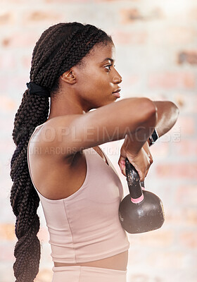 Buy stock photo Fitness, workout and black woman at gym with kettlebell for muscle strength and training side view. Wellness, exercise and focus of healthy girl lifting weight with concentration for body endurance.
