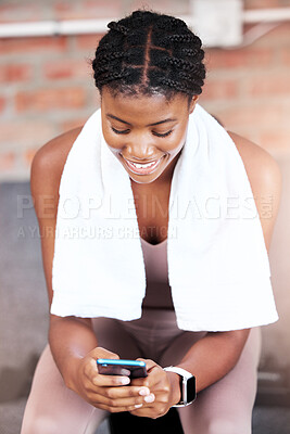 Buy stock photo Black woman, gym and smile with phone, social media or chatting on web, app or internet on break from workout. Woman, smartphone and fitness with comic meme, funny video or social network at training
