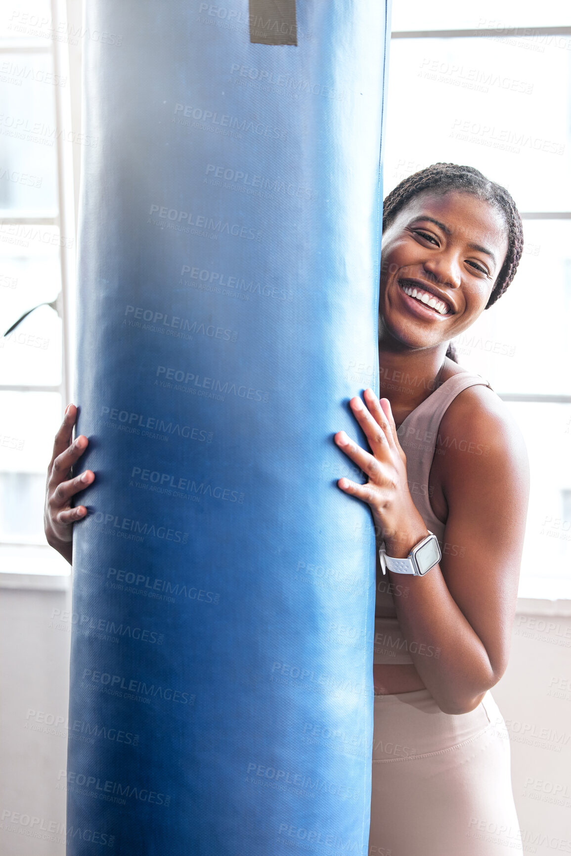 Buy stock photo Fitness, sport and boxing portrait with a woman holding a punching bag in a boxing gym for strength. Exercise, training and happy face of a martial arts fighter taking a break from kickboxing 