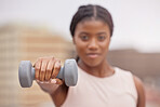 Fitness, dumbbell or black woman in a city training, workout or arm exercise for strong muscles or growth. Blurry, motivation or healthy African girl exercising for body development on a rooftop