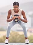 Rooftop fitness, kettlebell and black woman training for sports, body motivation and urban workout in the city of Turkey. Exercise, strength training and portrait of an African athlete with weights