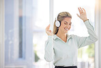 Business woman, headphones and dance in office, relax or celebrate success. Female entrepreneur, ceo and lady with earphones for music, audio or radio for stress relief, dancing or smile in workplace