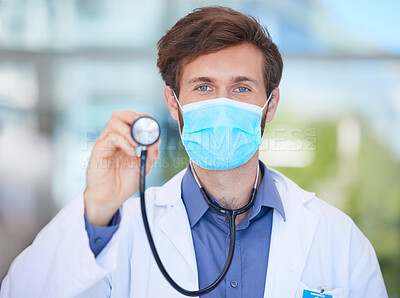 Buy stock photo Covid, cardiology and portrait of doctor with stethoscope to check, test and measure heart rate in clinic. Healthcare, face mask and male cardiologist for heart health, wellness and medical care