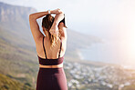 Fitness, woman and stretching arm on mountain for exercise, training or workout in the outdoors. Active female in warm up stretch during sunrise for spiritual yoga health, cardio or run in Cape Town