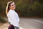 Woman runner, street and nature for portrait, smile and fitness in summer for health with blurred background. Happy athlete, marathon training and running workout for wellness, self care and exercise