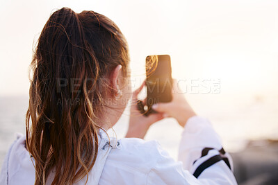 Buy stock photo Woman, back or phone picture of beach sunset by ocean or sea in nature environment, holiday vacation or Canada travel location. Student, tourist or influencer on mobile photography technology or vlog