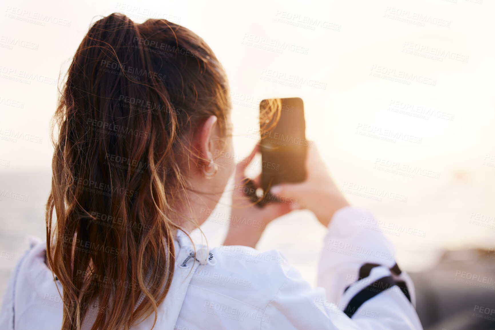 Buy stock photo Woman, back or phone picture of beach sunset by ocean or sea in nature environment, holiday vacation or Canada travel location. Student, tourist or influencer on mobile photography technology or vlog