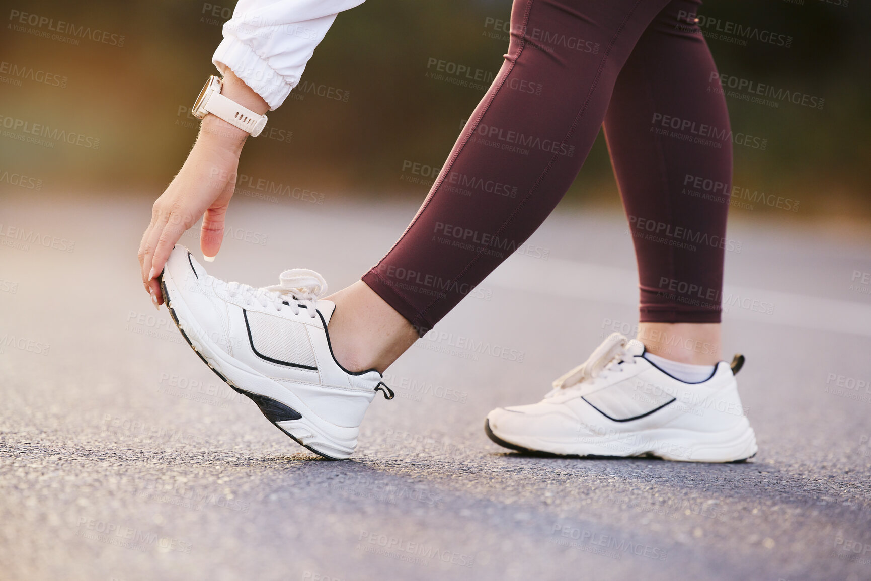 Buy stock photo Feet, fitness and stretching woman in street for running, outdoor training and exercise with sneakers, shoes or sports gear marketing. Hand, foot and sports, athlete or runner on road for workout