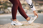 Stretching, legs and woman on a beach rock, start fitness and yoga exercise in nature of Portugal. Warm up, training and feet of an athlete at the ocean for spiritual health, cardio or pilates