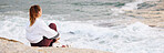 Beach, woman and relax for peace and thinking on rock for calm positive mindset, watching ocean waves or freedom vision outdoor. Zen meditation, mindfulness and mental health at Sydney seaside 