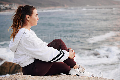 Buy stock photo Woman, beach and thinking about future, freedom and life on a rock with zen, peace and calm ocean for mindfulness, meditation and mental health. Female at sea to relax on nature holiday in Sydney