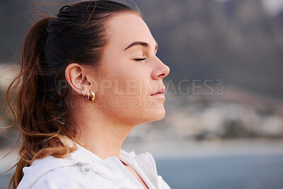 Buy stock photo Woman, face and meditation outdoor, calm and spiritual freedom at beach, prayer and breathe in nature. Young female, prayer and eye closed at ocean, balance mindset and zen faith on holiday vacation