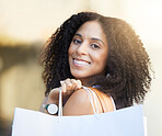 Fashion woman, face or shopping bags in urban city in Brazilian retail therapy, clothes sales or clothing boutique promotion. Portrait, smile or happy customer with gifts, trendy or curly hair style 